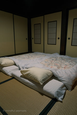 Traditional Japanese room with tatami mats and futon mattress.