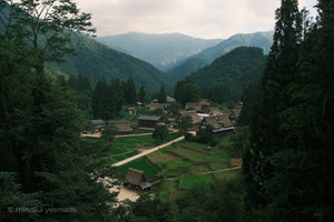 Traditional Japanese village nestled in a mountainous forested area