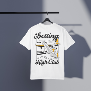 White t-shirt with Getting High Club airplane graphic and text on a hanger against a gray background