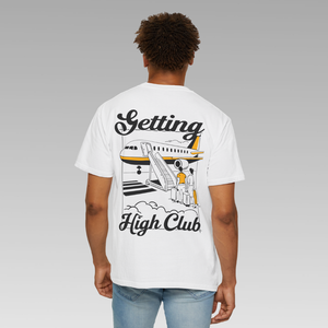Person wearing a white t-shirt with 'Getting High Club' flying design on the back, standing against a gray background.