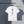White t-shirt with Japanese characters on the back against of Ichi-go Ichi-e design on a hanger against a dark background