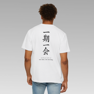 Person wearing a white t-shirt with black Japanese writing (ichi-go ichi-e) text on the back against a gray background