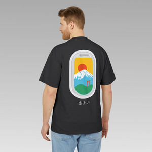 Man wearing a black t-shirt with a graphic design of Mount Fuji against a gray background