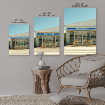 Three Lawson store images displayed on a wall with a sofa and side table in the foreground.