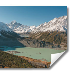 Scenic view of a lake surrounded by snow-capped mountains. Features Mount Cook / Aoraki and nearby lakes in New Zealand.