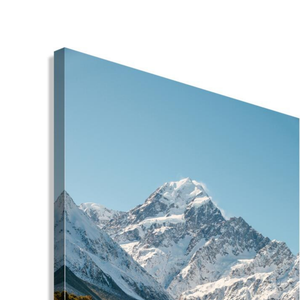 Snowy mountain peak with a clear blue sky. Features Mount Cook / Aoraki and nearby lakes in New Zealand.