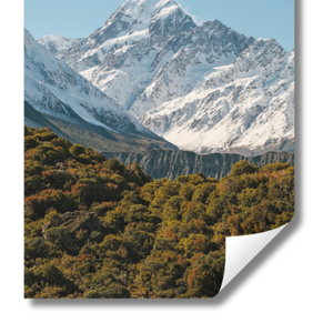 Snow-capped mountains with green valleys on a clear day