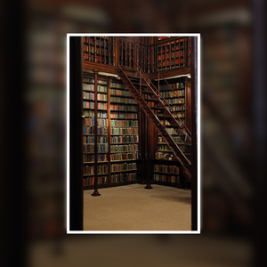 Library with bookshelves and a wooden staircase