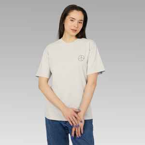 Woman wearing a beige t-shirt with small mindful yesmads logo on a gray background