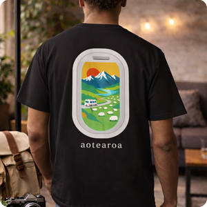 Person wearing a black t-shirt with a colorful New Zealand graphic and 'aotearoa' text on the back.